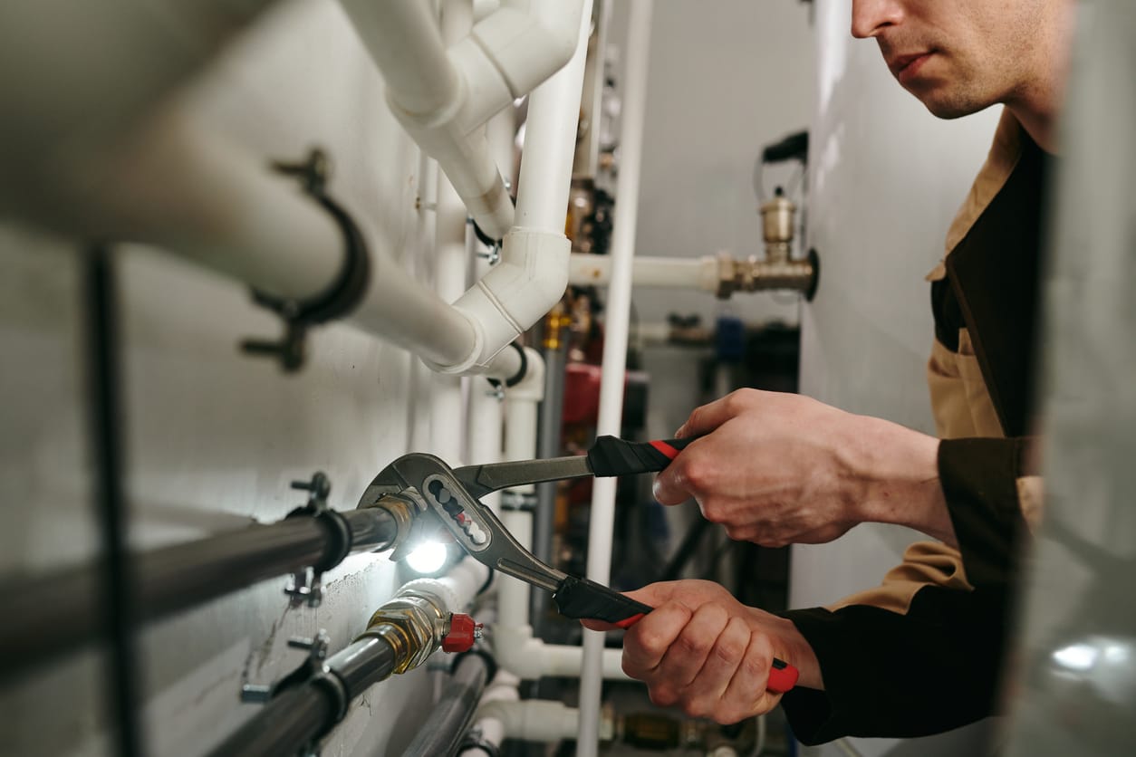 Plumbers maintaining commercial plumbing pipes in Ocoee