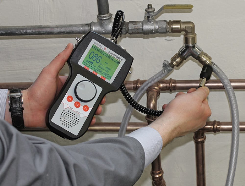 Plumber testing pipes with electronic leak detection equipment in Ocoee