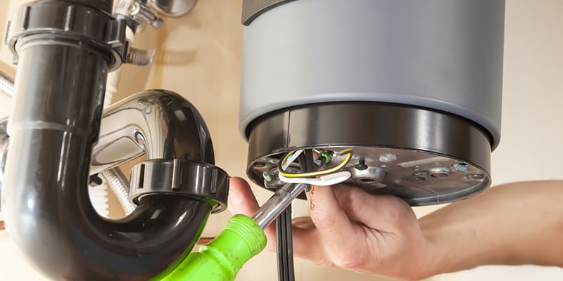 Technician repairing the heating element of a water heater in Ocoee