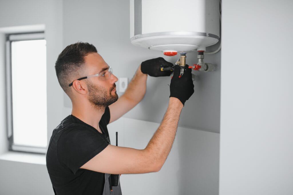Technician performing water heater maintenance in Ocoee