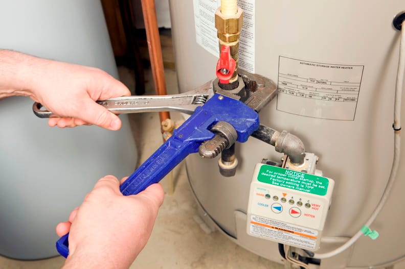 Plumber repairing a water heater valve in Ocoee